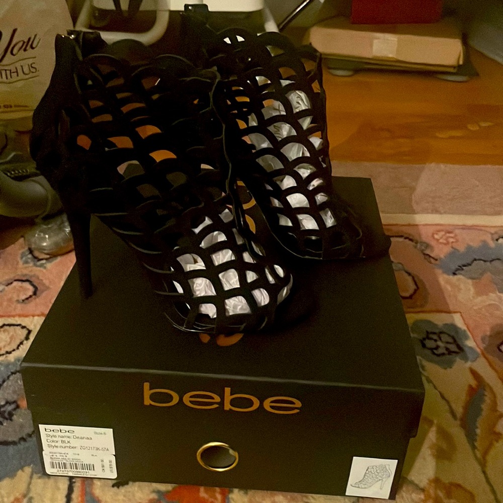 Size 6. Black fishnet heeled booties. Condition 10/10. From bebes.